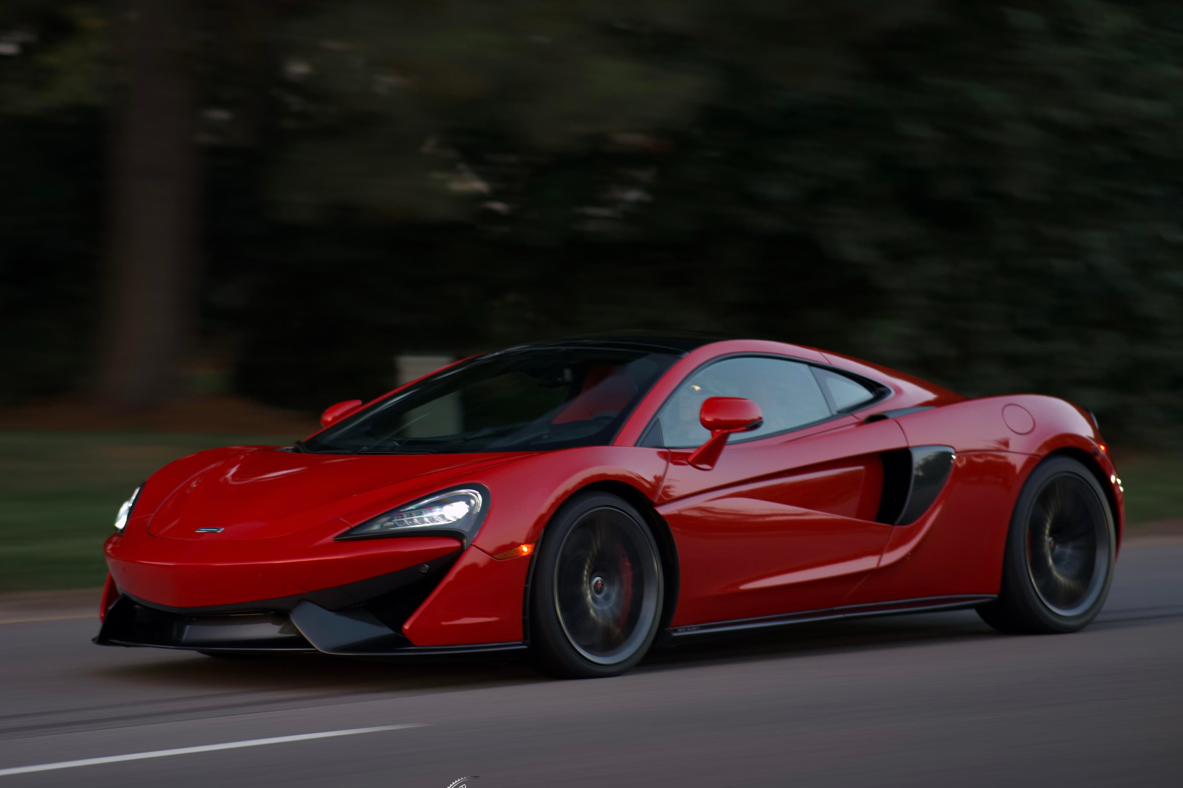McLaren 570GT in Papaya Orange on a coastal Virginia road
