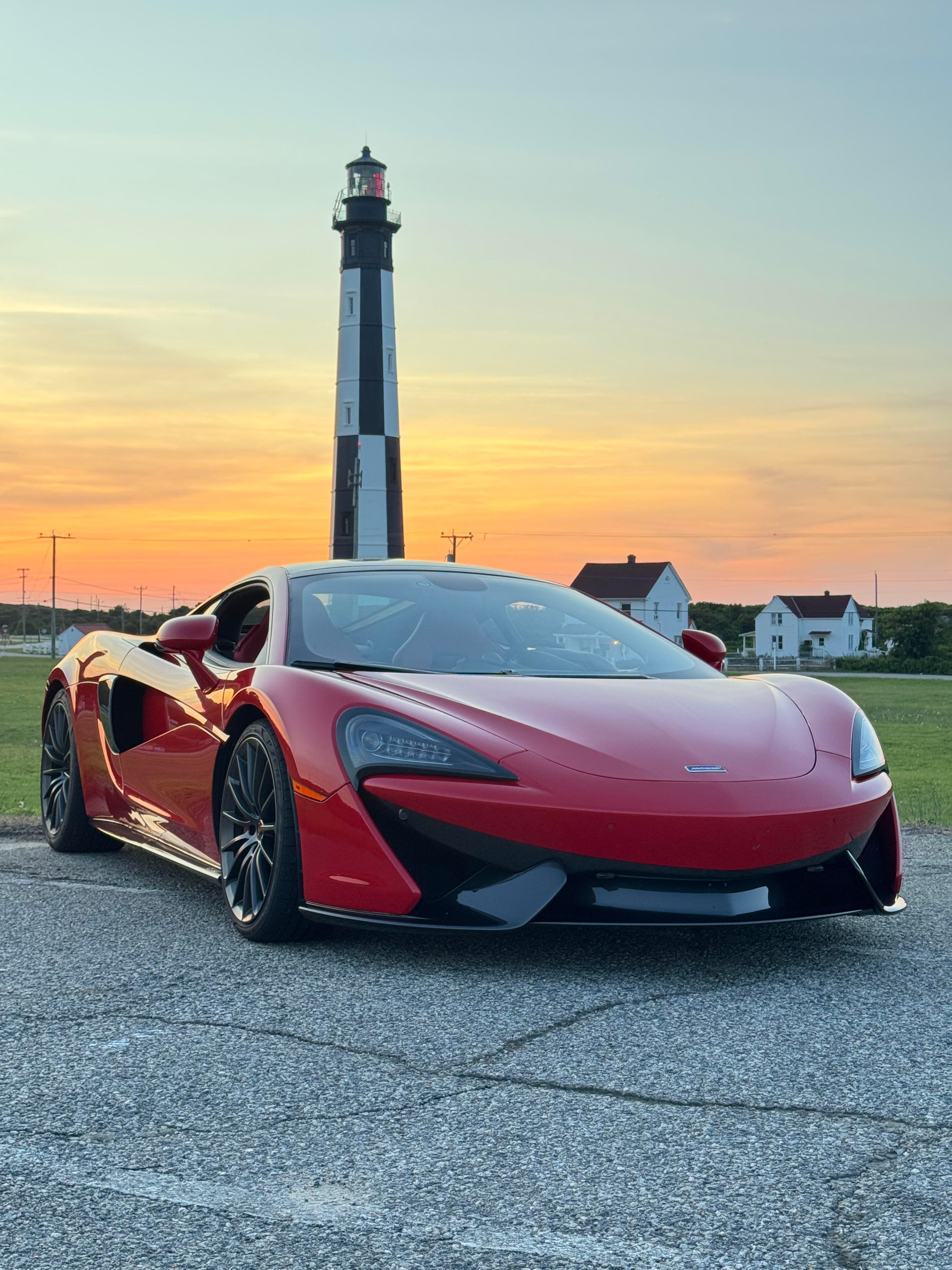 McLaren parked near a coastal Virginia lighthouse at sunset